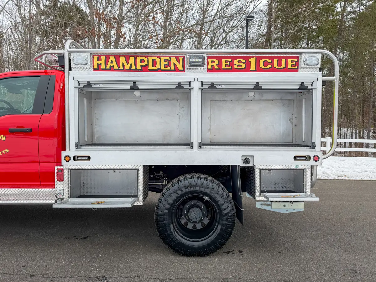 Passenger-side compartments opened to reveal empty shelf bays.